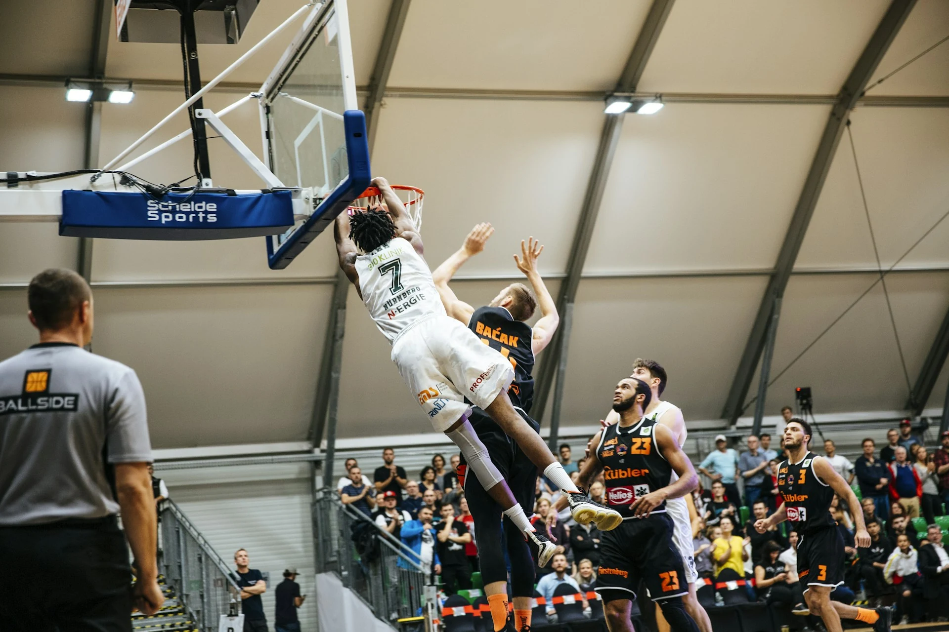 Players competing at the basket during a basketball game