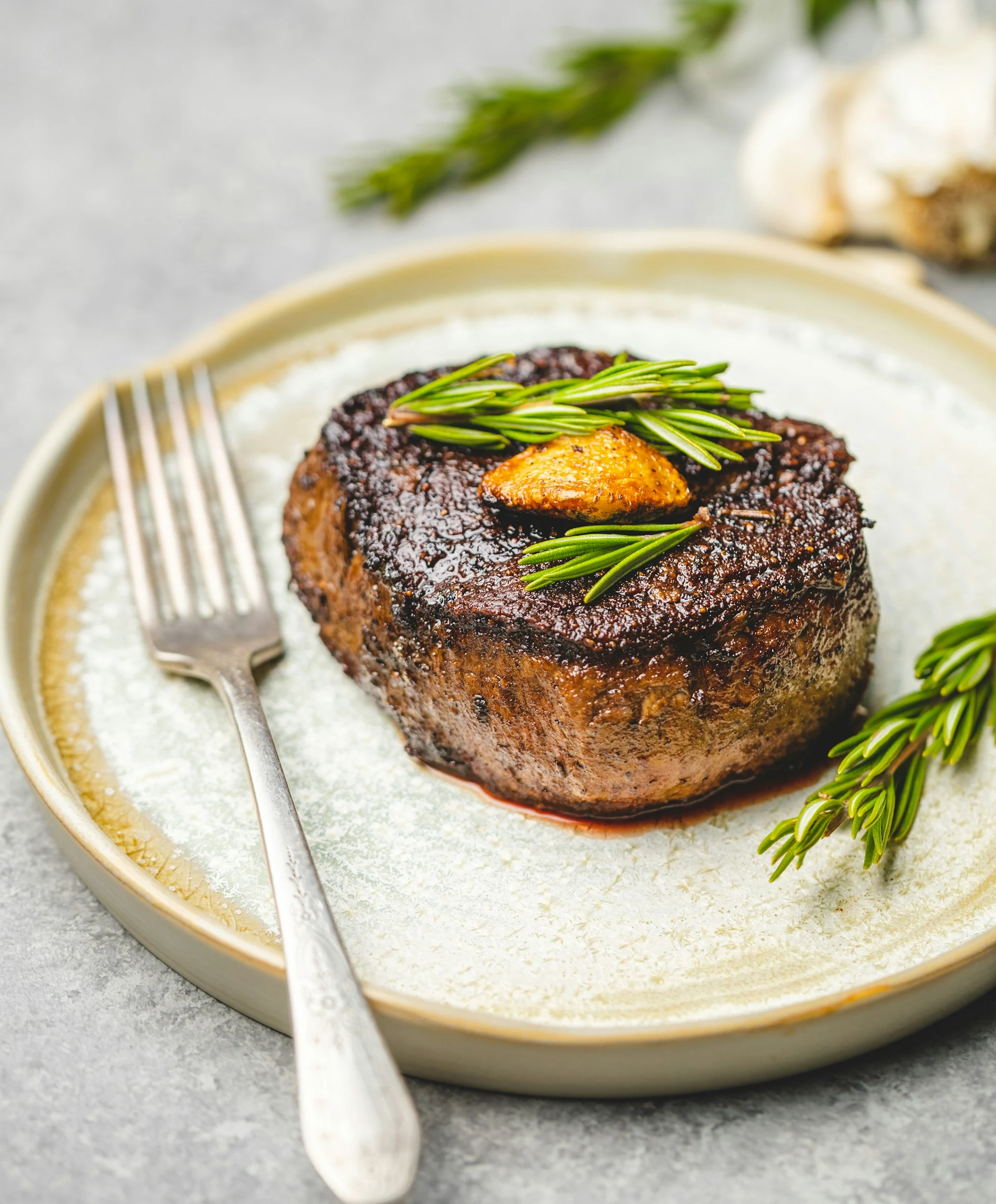 Cooked steak served on a plate with accompaniments